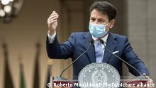 Italian Premier Giuseppe Conte announces new rules to curb the spread of COVID-19, in Rome, Sunday, Oct. 25, 2020. For at least the next month, people outdoors except for small children must now wear masks in all of Italy, gyms, cinemas and movie theaters will be closed, ski slopes are off-limits to all but competitive skiers and cafes and restaurants must shut down in early evenings, under a decree signed on Sunday by Italian Premier Giuseppe Conte, who ruled against another severe lockdown despite a current surge in COVID-19 infections. (Roberto Monaldo/LaPresse via AP) |