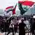 Protesters in Basra wave Iraqi flags