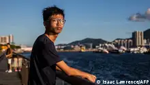 This picture taken on August 8, 2020 teenager shows Tony Chung posing near the water in Hong Kong. - Chung said he was walking through a shopping mall when police officers from Hong Kong's new national security unit swooped, bundled him into a nearby stairwell and scanned his face to unlock his phone. Chung's alleged crime was to write comments on social media that endangered national security, one of four students -- including a 16-year-old girl -- detained for the same offence that day. (Photo by ISAAC LAWRENCE / AFP) 