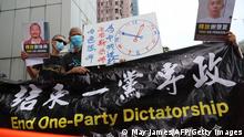 Pro-democracry activists holding banners demonstrate outside the Chinese liaison office during China's National Day in Hong Kong on October 1, 2020.