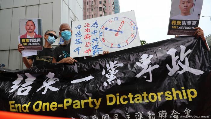 Pro-democracry activists holding banners demonstrate outside the Chinese liaison office during China's National Day in Hong Kong on October 1, 2020.