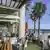 Diners are seen at a restaurant looking out towards St. Kilda Beach