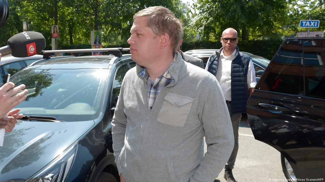 Far-right politician Rasmus Paludan speaks with reporters in a parking lot