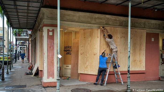 Gallery owners boarding up the gallery ahead of a storm (Kathleen Flynn/REUTERS)