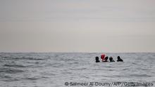 TOPSHOT - Migrants sit onboard a boat navigating in agitated waters between Sangatte and Cap Blanc-Nez (Cape White Nose), in the English Channel off the coast of northern France, as they attempt to cross the maritime borders between France and the United Kingdom on August 27, 2020. - The number of migrants crossing the English Channel -- which is 33,8 km (21 miles) at the closest point in the Straits of Dover -- in small inflatable boats has spiralled over the summer of the 2020. According to authorities in northern France some 6,200 migrants have attempted the crossing between January 1 and August 31, 2020, compared with 2,294 migrants for the whole of 2019. (Photo by Sameer Al-DOUMY / AFP) (Photo by SAMEER AL-DOUMY/AFP via Getty Images)