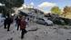People stand near a building damaged by an earthquake in Izmir, Turkey People stand near a building damaged by an earthquake in Izmir, Turkey
