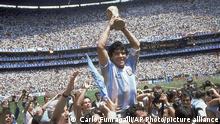 FILE - In this June 29, 1986, file photo, Diego Maradona, holds up the trophy, after Argentina beat West Germany 3-2 in the World Cup soccer final match, at the Atzeca Stadium, in Mexico City. The 21st World Cup begins on Thursday, June 14, 2018, when host Russia takes on Saudi Arabia. (AP Photo/Carlo Fumagalli, File) |