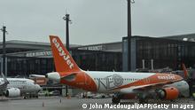 Aircrafts of airlines Lufthansa (l) and Easyjet, the first ones to arrive at Berlin's airport Berlin Brandenburg Airport Willy Brandt, stand in front of the main terminal during the opening ceremony, in Schoenefeld, southeast of Berlin, on October 31, 2020. - Passenger flights are to begin landing on October 31, 2020 at Berlin's new international airport, a moment many Germans thought they might never see after years of embarrassing delays and spiralling costs. (Photo by John MACDOUGALL / AFP) (Photo by JOHN MACDOUGALL/AFP via Getty Images)