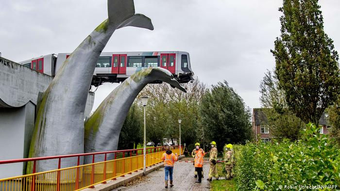 Authorities work out how to remove the Dutch metro train perched on a giant whalt sculpture (Robin Utrecht/ANP/AFP)