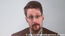 ARCHIV - 17.09.2019, Berlin: Edward Snowden ist auf einer Video-Leinwand in der Urania zu sehen, während er bei einer Liveübertragung über sein Buch «Permanent Record: Meine Geschichte» spricht. Der US-Whistleblower hat in Russland nach Angaben seines Moskauer Anwalts ein Daueraufenthaltsrecht erhalten (zu dpa «US-Whistleblower Snowden erhält unbefristeten Aufenthalt in Russland») Foto: Jörg Carstensen/dpa +++ dpa-Bildfunk +++ | Verwendung weltweit