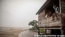 Children sit on a beach house window as Hurricane Eta approaches in Bilwi, Puerto Cabezas, Nicaragua, on November 2, 2020. - Eta rapidly intensified to a Category 4 hurricane on Monday as it bore down on the Caribbean coast of Nicaragua and Honduras, threatening the Central American countries with catastrophic winds and floods. (Photo by INTI OCON / AFP) (Photo by INTI OCON/AFP via Getty Images)