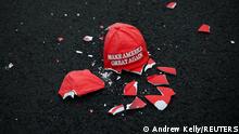 A broken Make America Great Again hat model lies on the ground as people gather at Black Lives Matter Plaza in Washington, U.S. November 3, 2020. REUTERS/Hannah McKa