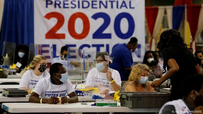 Electoral workers busy opening ballots in West Palm Beach, Florida (Joe Skipper/REUTERS)