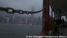 A woman looks at her mobile phone while traveling on ferry in Hong Kong Thursday, May 28, 2020. China’s legislature endorsed a national security law for Hong Kong on Thursday that has strained relations with the United States and Britain and prompted new protests in the territory. (AP Photo/Kin Cheung) |