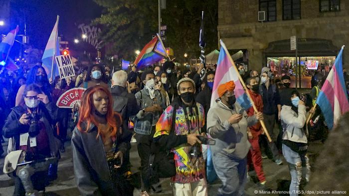 Black Lives Matter protesters carrying flags march in support of a fair vote count the day after elections in 2020