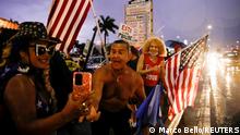 A supporter of U.S. President Donald Trump reacts during a protest about the early results of the 2020 presidential election in the Westchester neighborhood in Miami, Florida, U.S. November 5, 2020. The placard reads: This is a fraud. REUTERS/Marco Bello