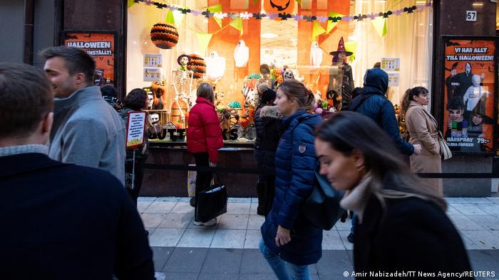 People queue outside a shop selling Halloween costumes, amid the outbreak of the coronavirus disease (COVID-19), in central Stockholm