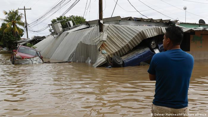 Inundaciones en Centroamérica: un hombre, con el agua hasta la cintura, en Honduras, tras el paso del huracán Eta.