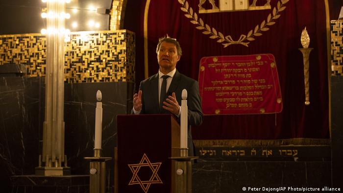 Rene de Reuver, speaking on behalf of the General Synod of the Protestant Church in the Netherlands, reads a statement at the Rav Aron Schuster Synagogue in Amsterdam, Netherlands