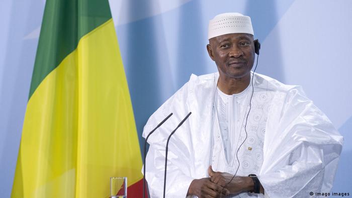 Mali´s former president Amadou Toumani Toure next to a flag of his country