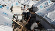 14.10.2020 *** Men repair a tent following a storm, in the Kara Tepe camp for refugees and migrants on the island of Lesbos, Greece, October 14, 2020. REUTERS/Elias Marcou