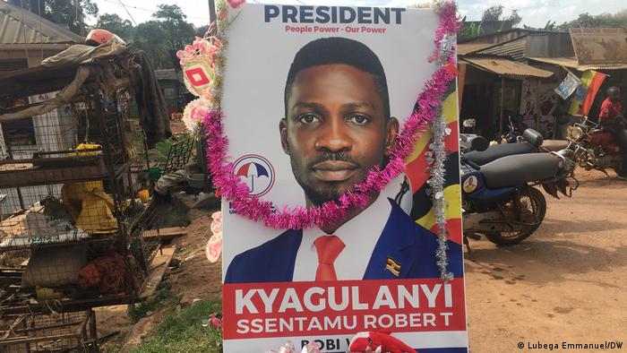 A supporter holds up a portrait of Robert Kyagulanyi, aka Bobi Wine