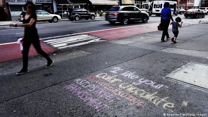 Colorful chalk grafitti on a street in New York raising awarness of public sexual harassment of women