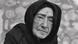 An elderly woman wearing a black cloth around her head An elderly woman wearing a black cloth around her head