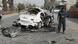 An Afghan police officer stands next to the wreckage of a car bombed in Lashkar Gah, Helmand province An Afghan police officer stands next to the wreckage of a car bombed in Lashkar Gah, Helmand province
