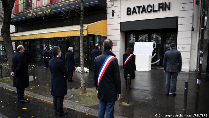 People stand outside the Bataclan concert venue for a memorial event in Paris