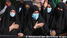 Shiite Muslim women take part in a ritual ahead of Arbaeen, which marks the end of the 40-day mourning period for the seventh century killing of Imam Hussein, Prophet Mohammed's grandson, in Iraq's central holy city of Karbala, on October 5, 2020. - usually one of the world's biggest religious gatherings, Arbaeen, which falls on October 8, will take place under restrictions this year, in a bid to stem the spread of the COVID-19 pandemic. (Photo by Mohammed SAWAF / AFP) (Photo by MOHAMMED SAWAF/AFP via Getty Images)