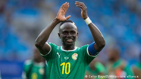 Sadio Mané applauds fans while in action for Senegal