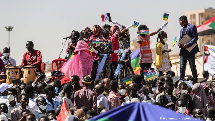 People in Khartoum sing and play music on the street as they celebrate the hosting of peace leaders in November 2020