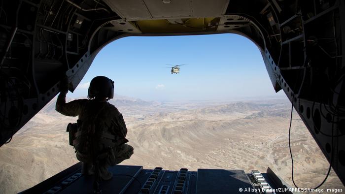 Soldier looking on 101st Airborne looking out on Chinook helicopter