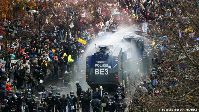 Berlin | Anti-Corona Demo. Ein Wasserwerfer der Polizei inmitten einer großen Menschenmenge 