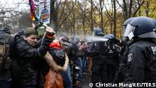 A police officer uses a pepper spray on demonstrators during a protest against the government's coronavirus disease (COVID-19) restrictions, near the Brandenburger Gate in Berlin, November, 18, 2020. REUTERS/Christian Mang