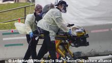 November 9, 2020, Albuquerque, New Mexico , USA: Albuquerque Ambulance EMTs wheel a patient on a gurney in front of Presbyterian Hospital near Downtown Albuquerque. New Mexico hospitals have been stretched to their limits due to the huge spike in Covid- 19 cases. (Credit Image: © Adolphe Pierre-Louis/Albuquerque Journal via ZUMA Wire |