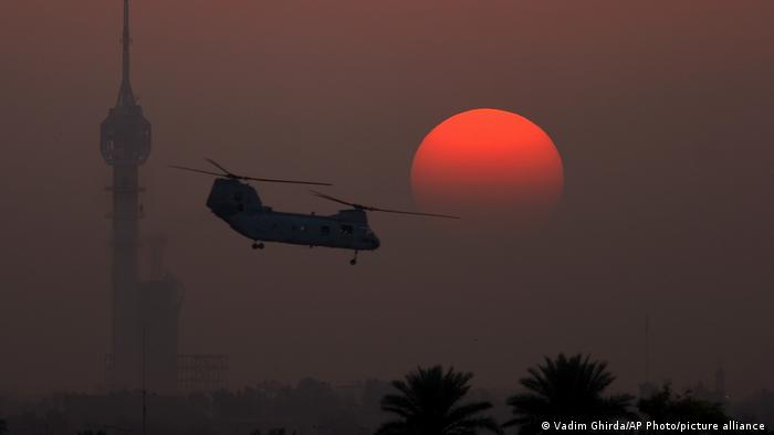 An US transport helicopter takes off at sunset from the Green Zone in Baghdad, Iraq