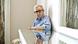 Woody Allen seated by a window, peers at his reflection in the mirror on the surface of a table Woody Allen seated by a window, peers at his reflection in the mirror on the surface of a table