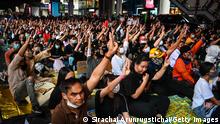 BANGKOK, THAILAND - NOVEMBER 21: Protesters makes three finger salutes in the Siam area on November 21, 2020 in Bangkok, Thailand. Pro-democracy protesters kept up the pressure on the Thai government with a protest organised by students on Saturday after tensions flared between demonstrators and police earlier in the week. (Photo by Sirachai Arunrugstichai/Getty Images)