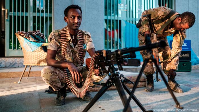  A member of the Amhara Special Forcessits next to a machine gun at an improvised camp in the front of a shop in Humera, Ethiopia, on November 22, 2020