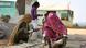 Banjara women wearing colorful clothing and metal jewelry weaving Banjara women wearing colorful clothing and metal jewelry weaving