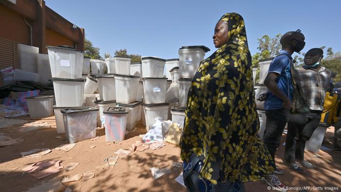 A woman walks past ballot boxes in Burkina Faso