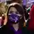 Women in masks with slogans about fighting violence against women