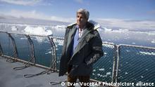 John Kerry standing in front of the Jakobshavn Glacier in Greenland