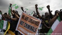 People hold banners as they demonstrate on the street to protest against police brutality in Lagos, Nigeria, Monday Oct. 19, 2020. For more than two weeks Nigeria has been rocked by demonstrations by many young Nigerians protesting alleged police brutality. The protests began in response to a video that circulated online showing a man being beaten, apparently by members of the police Special Anti Robbery Squad, known as SARS. (AP Photo/Sunday Alamba) |