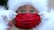 Face of a man dressed as Santa Claus, weraing a red mask Face of a man dressed as Santa Claus, weraing a red mask