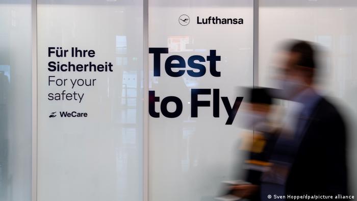 A Lufthansa airport sign advertises pre-flight testing