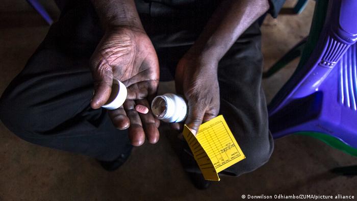 A person in Kenya with HIV medication in their hands