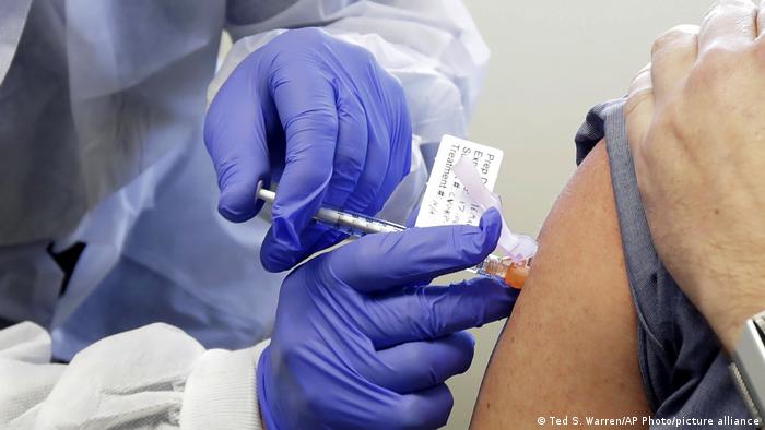 A person receives a shot of the new coronavirus vaccine